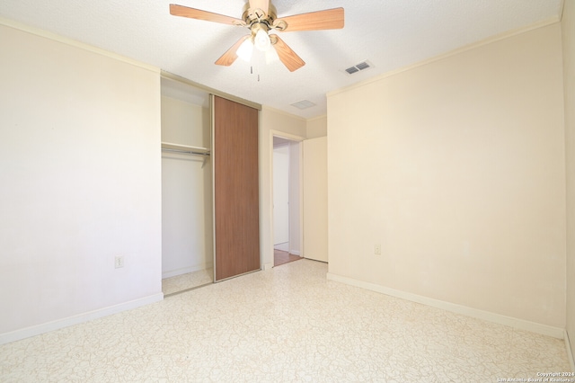 unfurnished bedroom with a closet, a textured ceiling, and ceiling fan