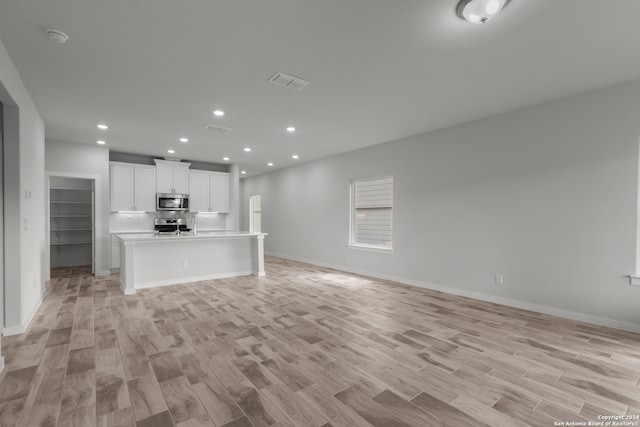 unfurnished living room with light hardwood / wood-style flooring