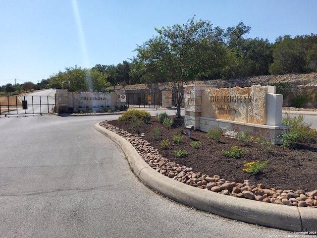 community sign with a gate and fence