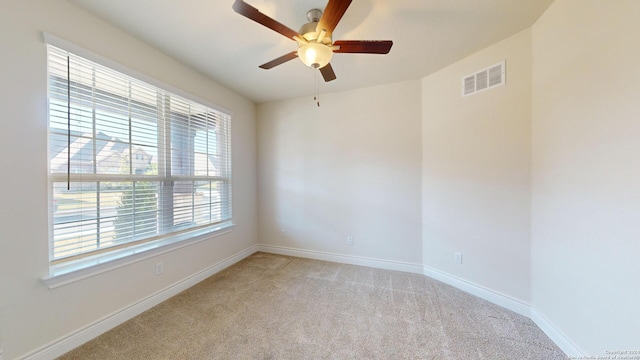 spare room with light carpet and ceiling fan