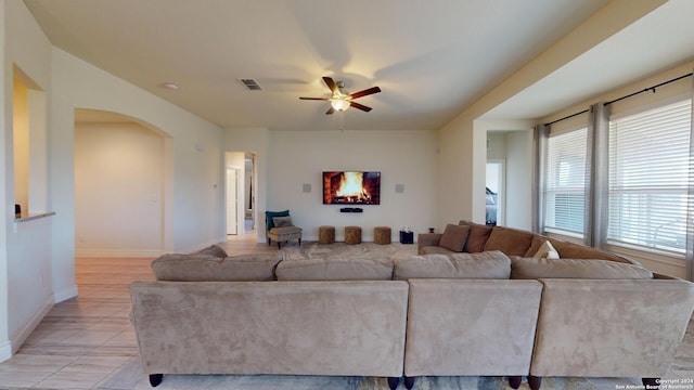 tiled living room with ceiling fan