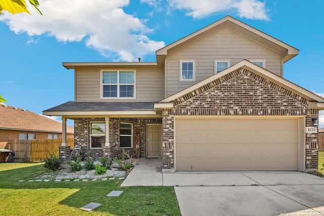 view of front of house featuring an attached garage, fence, a front yard, brick siding, and driveway