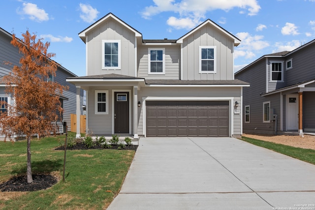 view of property featuring a front lawn and a garage