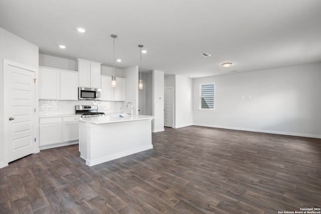 kitchen featuring stainless steel appliances, dark hardwood / wood-style floors, decorative light fixtures, and white cabinetry