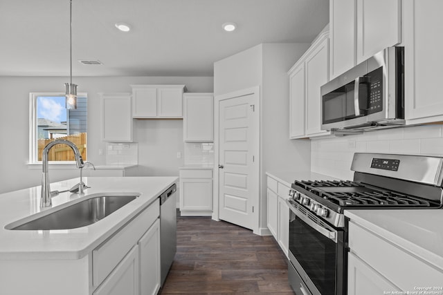 kitchen with appliances with stainless steel finishes, dark hardwood / wood-style floors, and white cabinets