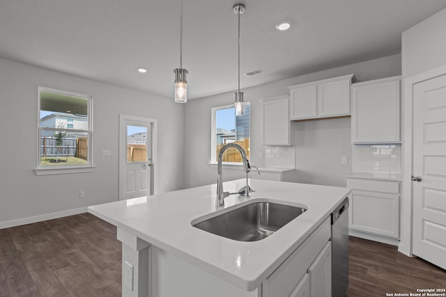 kitchen with a kitchen island with sink, sink, dark hardwood / wood-style flooring, and white cabinetry