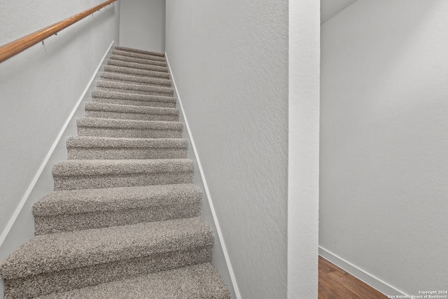 stairs with hardwood / wood-style floors