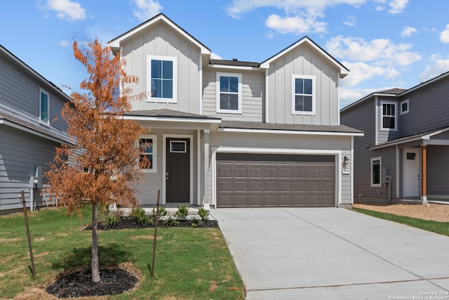 view of front of home with a front yard and a garage