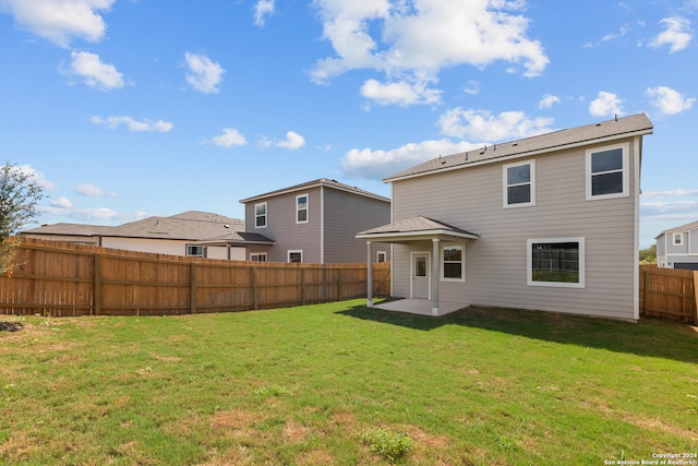 back of house featuring a yard and a patio area