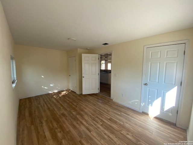 unfurnished bedroom with wood-type flooring