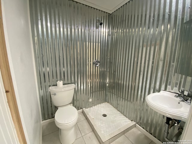 bathroom with sink, tile patterned flooring, walk in shower, and toilet