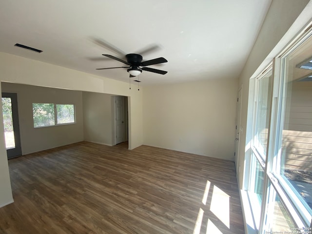 spare room featuring dark hardwood / wood-style flooring and ceiling fan