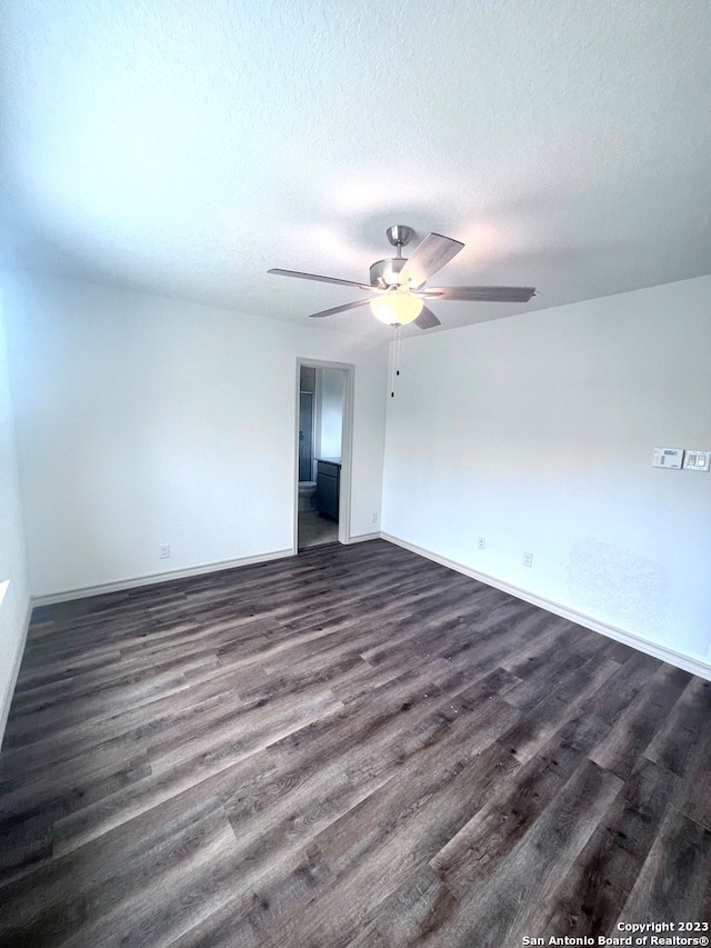 unfurnished room featuring ceiling fan, a textured ceiling, and dark hardwood / wood-style flooring