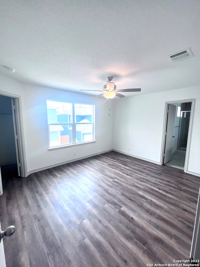 unfurnished room featuring ceiling fan, a textured ceiling, and dark hardwood / wood-style flooring