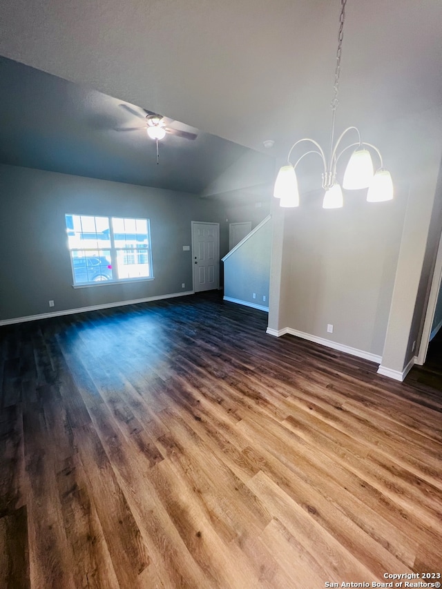 unfurnished living room featuring vaulted ceiling, wood-type flooring, and ceiling fan with notable chandelier