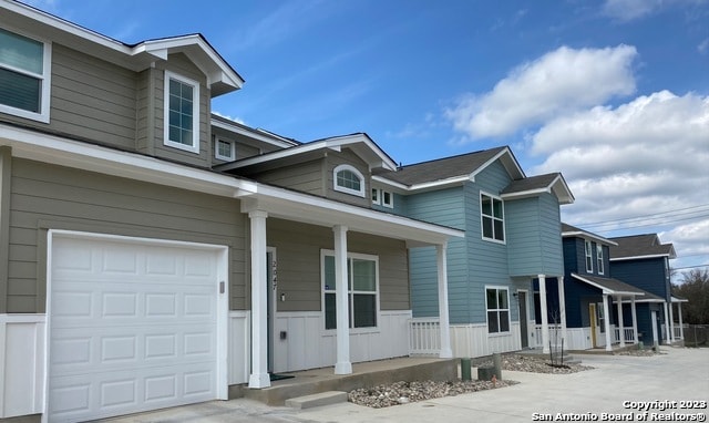 view of front of property featuring a porch and a garage