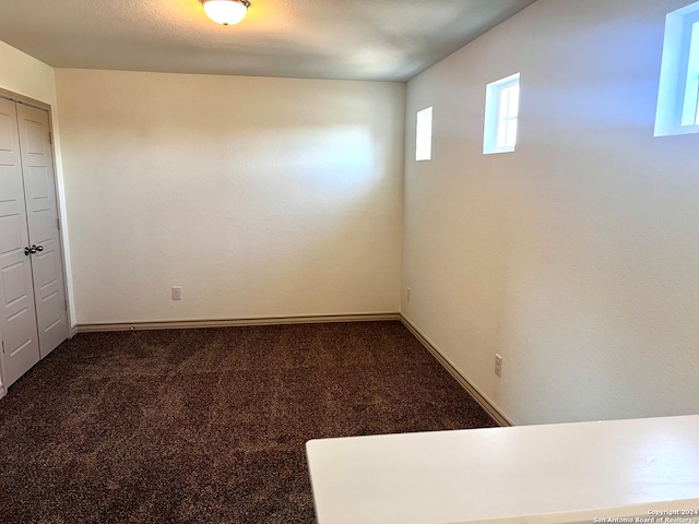 carpeted spare room with a textured ceiling