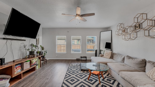 living room with dark hardwood / wood-style floors, a textured ceiling, and ceiling fan