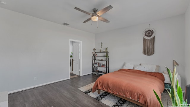 bedroom with dark hardwood / wood-style flooring and ceiling fan