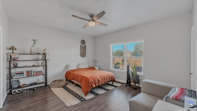 bedroom with ceiling fan and dark hardwood / wood-style floors