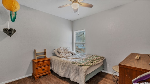 bedroom with ceiling fan and dark hardwood / wood-style floors