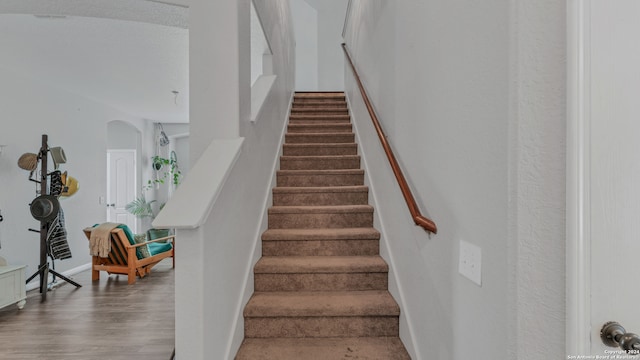 staircase featuring hardwood / wood-style flooring