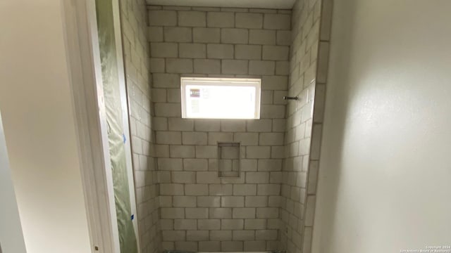 bathroom with a tile shower