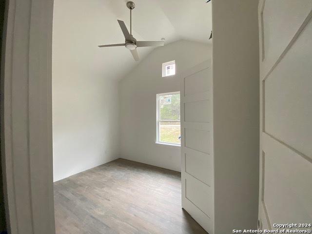 interior space featuring ceiling fan, light hardwood / wood-style flooring, and lofted ceiling