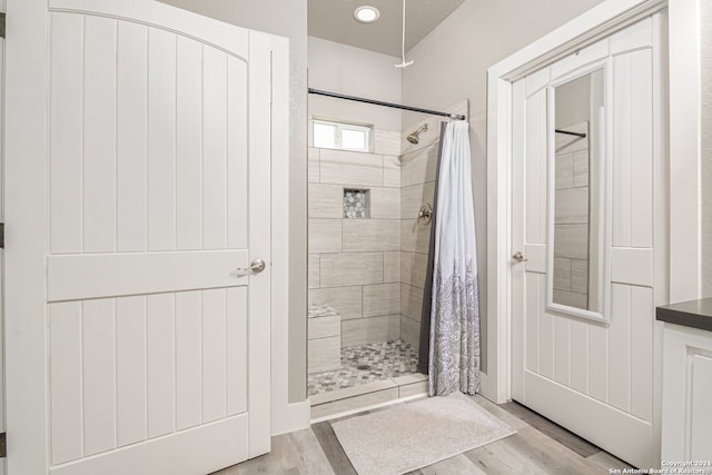 bathroom featuring walk in shower and hardwood / wood-style flooring