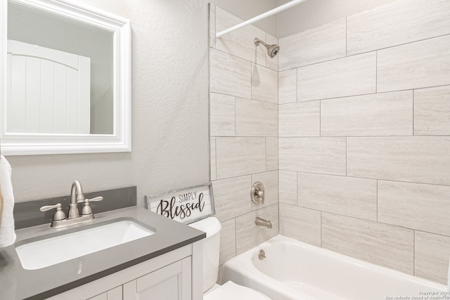 full bathroom with vanity, toilet, and tiled shower / bath