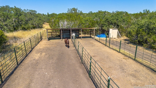 surrounding community featuring a rural view and an outdoor structure