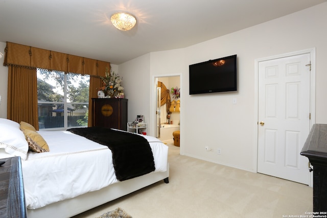 bedroom featuring ensuite bathroom and carpet floors