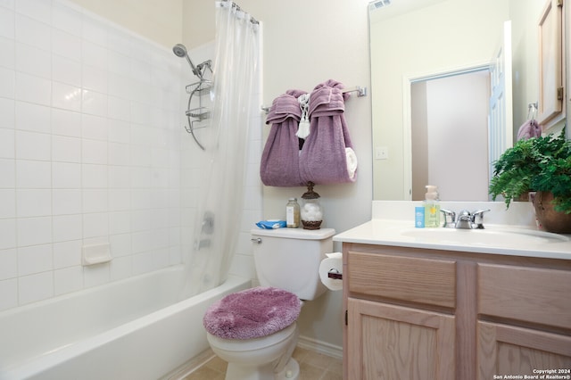 full bathroom with vanity, shower / bath combo with shower curtain, toilet, and tile patterned flooring