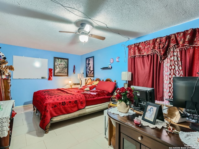 bedroom with ceiling fan and a textured ceiling