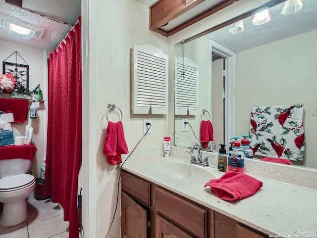 bathroom with vanity, tile patterned flooring, and toilet