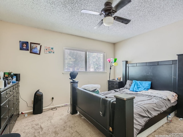 carpeted bedroom featuring ceiling fan and a textured ceiling