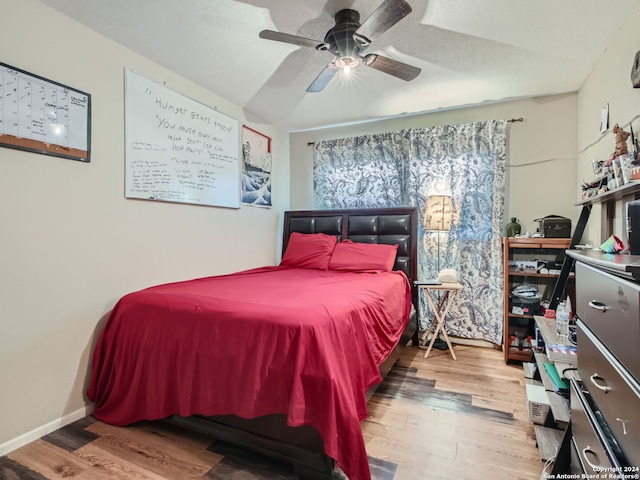 bedroom with wood-type flooring and ceiling fan