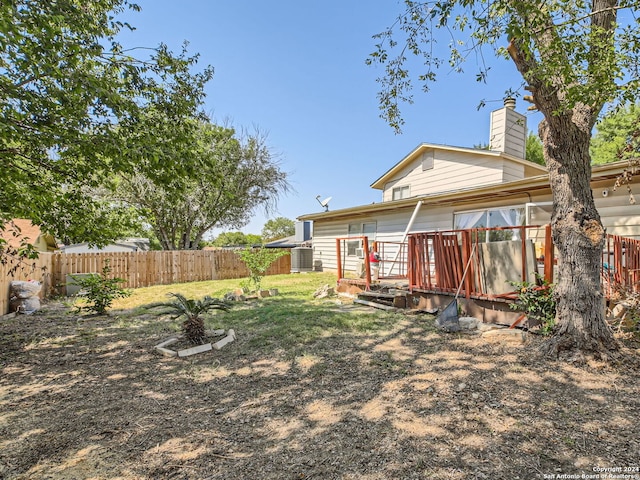 rear view of property featuring central AC unit