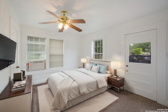 bedroom featuring cooling unit, dark colored carpet, and ceiling fan