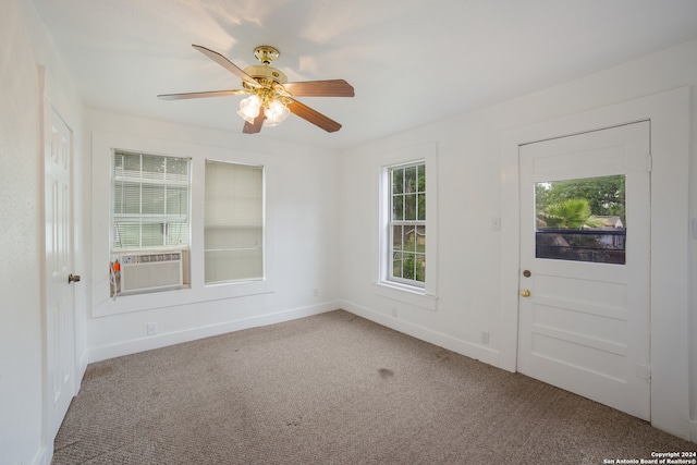 unfurnished room with cooling unit, ceiling fan, and carpet