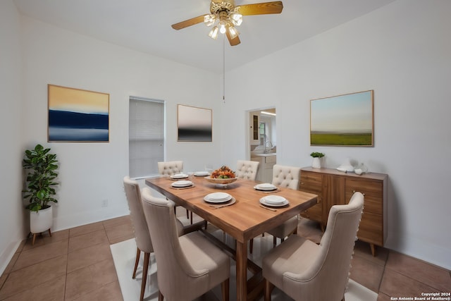 tiled dining space featuring sink and ceiling fan