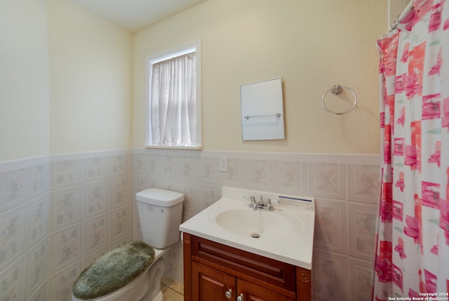 bathroom with a shower with curtain, tile walls, vanity, and toilet