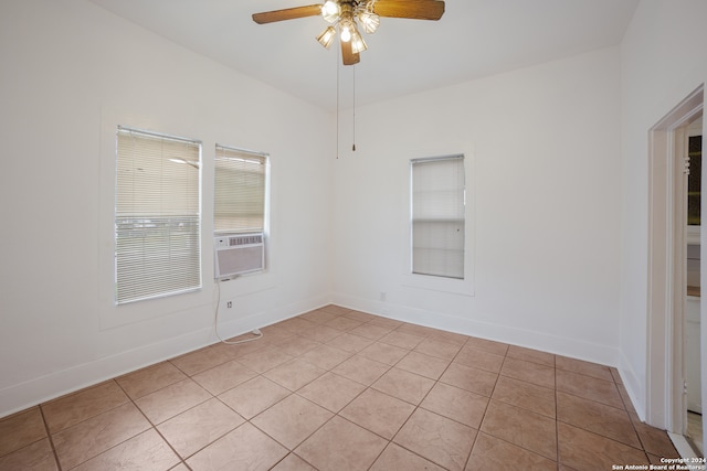 tiled spare room with ceiling fan and cooling unit