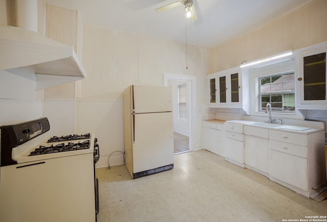 kitchen featuring ceiling fan, white cabinets, sink, white appliances, and extractor fan