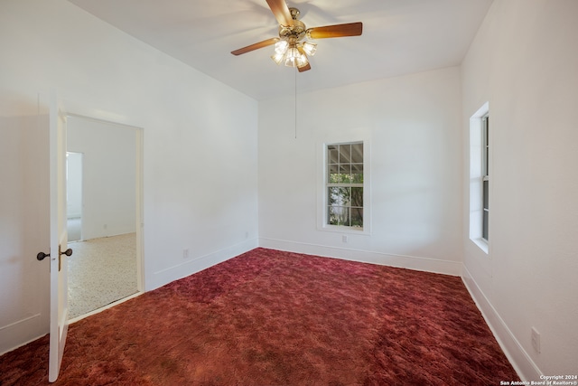 spare room with carpet floors, a healthy amount of sunlight, and ceiling fan