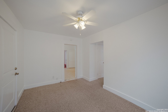 unfurnished room featuring ceiling fan and light carpet