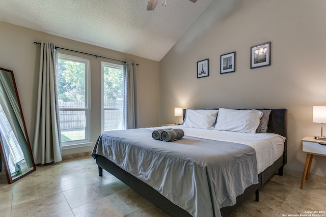 bedroom with ceiling fan, a textured ceiling, and vaulted ceiling