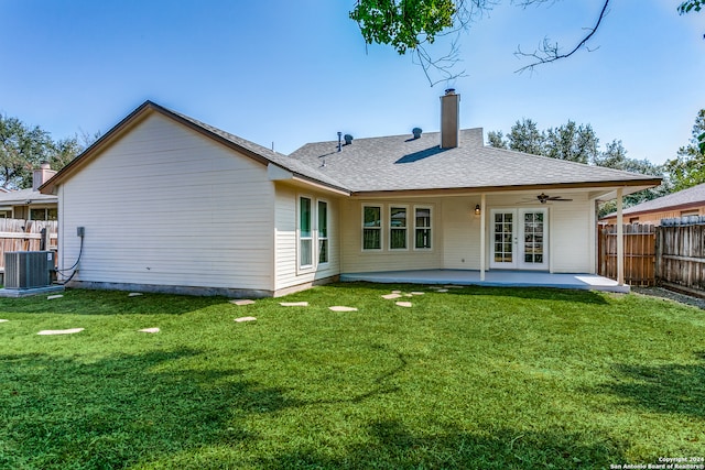 rear view of property with french doors, a yard, a patio area, and ceiling fan