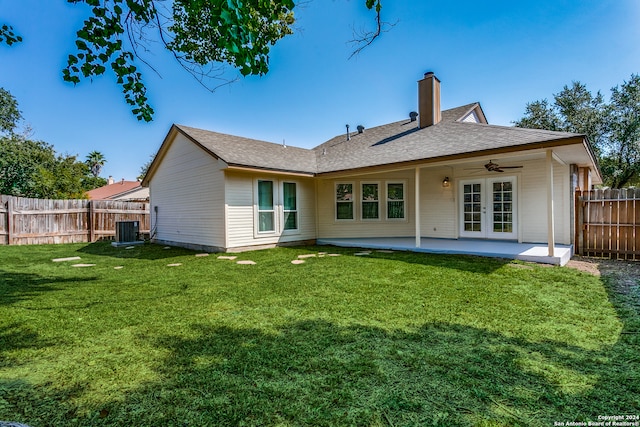 rear view of property featuring ceiling fan, a yard, a patio, and central air condition unit