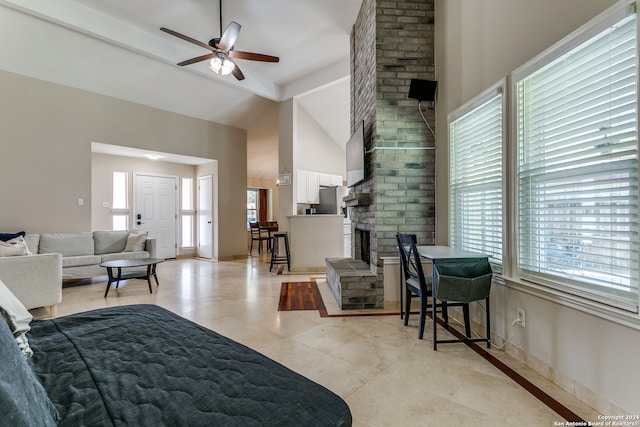 living room featuring light tile patterned flooring, high vaulted ceiling, beamed ceiling, and ceiling fan